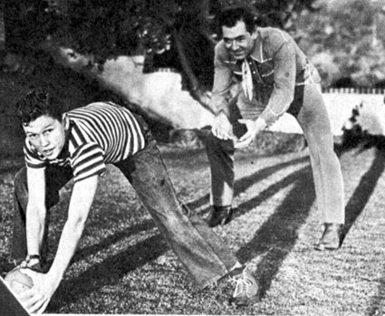In March 1946, Johnny Mack Brown shows his 12 year old son Lachlan some of the moves that made Johnny famous in the Rose Bowl game of 1925. 