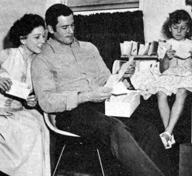 Clint Walker and his wife at the time, Verna Lucille, and daughter Valerie Jean, glance through fan mail in 1958.