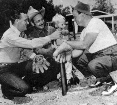 When he’s not making westerns for Monogram, Jimmy Wakely relaxes with friends and his son Johnny playing sandlot baseball or fishing. In this photo Jimmy, screen heavy Ted French, Jimmy’s 3 year old son Johnny and sidekick Dub “Cannonball” Taylor get ready for a game.