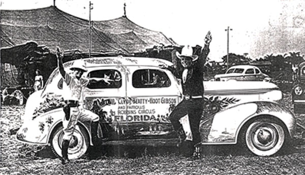 Clyde Beatty and Hoot Gibson beside a 1937 Studebaker in Jacksonville, FL, in October 1938 getting ready for the Robbins Circus tour.