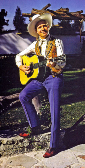 A very untypical outfit for Gene Autry as he strums his Martin guitar.