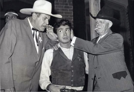 Ken Maynard offers words of wisdom to Tony Perkins who was set to star in “Tin Star” (‘57 Paramount). Those wisdom words won't be going out the other ear, Hoot Gibson is seeing to that. The two western greats, along with other former movie cowboys, attended a barbecue hoedown at Paramount hosted by Perkins to promote “Tin Star” which co-starred Henry Fonda. (Thanx to Jerry Whittington.)