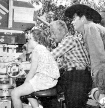 Dale Robertson's daughter, Rochelle, gets a few camera pointers from a "Tales of Wells Fargo" cameraman and dad Dale. Taken in late 1959.