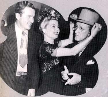 Jimmy Wakely and singer Frances Langford clown around with bandleader Kay Kyser circa 1945. 