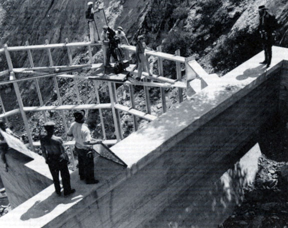 The crew sets up a shot at Pacoima Dam for the Republic serial “Zorro Rides Again” (‘37). John Carroll...or probably his stuntman, stands ready for the shot to the right.