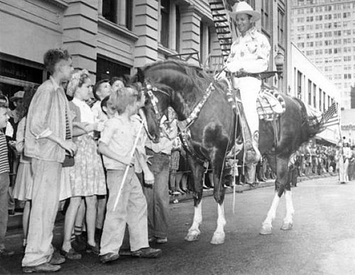 Gene and Champion greet children on the streets of Houston during the January 29, 1947, Houston Fat Stock Show Rodeo parade.