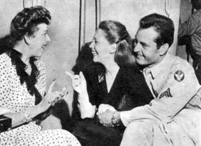Army Air Corps Corporal George Montgomery listens while wife Dinah Shore talks with radio’s Baby Snooks (Fannie Brice) in late 1944. George and Dinah were married from December 5, 1943 til May 9, 1963.