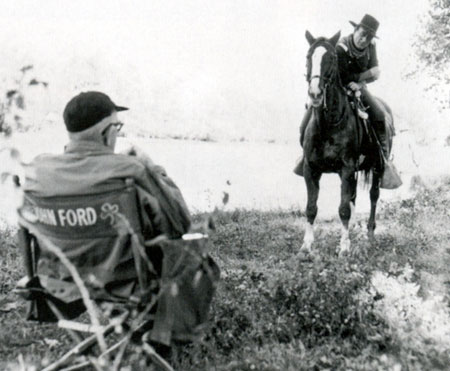 John Ford gives John Wayne a bit of direction on “The Horse Soldiers” (‘59).