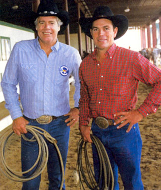 Rodeo rider Phil Lyne (right) with team roping partner Doug McClure (“The Virginian”, “Overland Trail”, “Barbary Coast”) at the 1986 Bum Phillips Invitational Celebrity Roping in Houston, Texas.