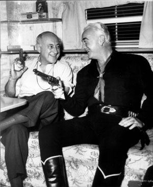 Director Cecil B. DeMille and Hopalong Cassidy compare six shooters. (Thanx to Bobby Copeland.)