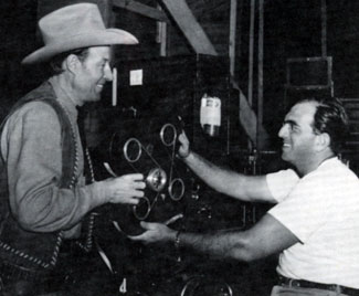 Bill Elliott in 1947 helps Republic’s Bob Wasserman load a camera.