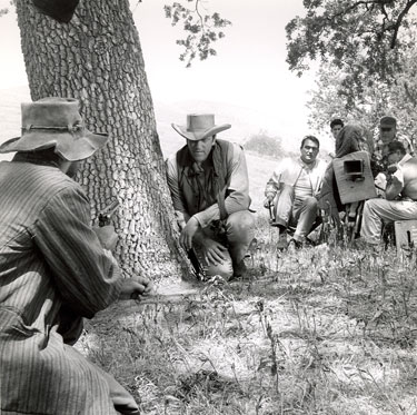 Director Andrew McLaglen guides James Arness through a scene for “Gunsmoke”. (Thanx to Neil Summers.)