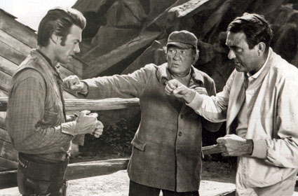 Victor McLaglen and son Andrew McLaglen (directing) give Clint Eastwood a few pointers on the proper way to throw a punch on the set of “Rawhide” in ‘59.