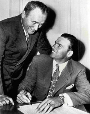 John Kimbrough starred in “Sundown Jim” and “Lone Star Ranger” for 20th Century Fox in 1942. He later served as an Army pilot in the Pacific Theater of Operations during WWII. Returning from service Kimbrough played football with the Los Angeles Dons of the All America Football Conference. Here L.A. Dons manager Slip Madigan is with Jarrin’ John whose football career was cut short by a series of heart attacks that started when he was only 30. He was forced to leave the game in ‘48 after three seasons with the Dons. 