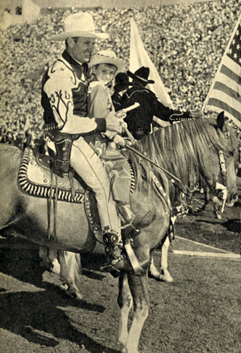 It was a day of thrills and spills for some 100,000 fans at the 5th Annual Sheriff’s Rodeo at the L.A. Coliseum in late 1949. The photo above of Gene Autry with fan Eleanor Truitt and the following six photos are all from that rodeo.