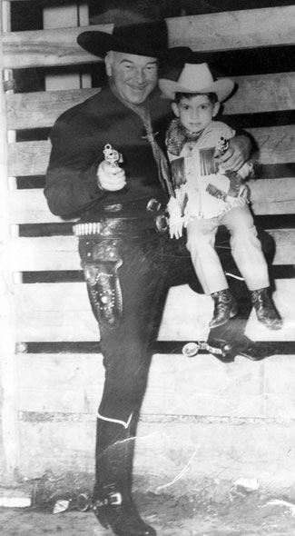 Hopalong Cassidy goes gunning with a young fan.
