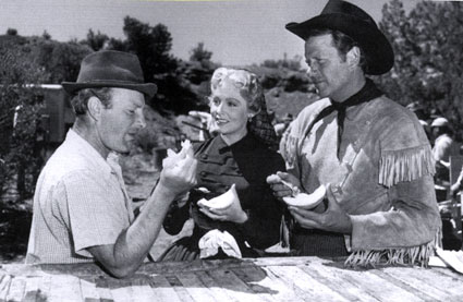 Director Roy Rowland, Arlene Dahl and Joel McCrea pause for a bite of melon while filming “The Outriders” (‘50 MGM).