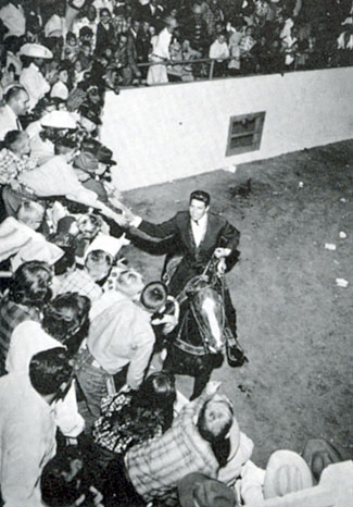 Dale Robertson shakes hands with fans at Tingley Coliseum at the New Mexico State Fair in Albuquerque in 1959.