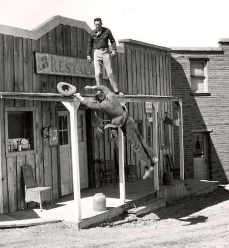 A great action shot from TV's “Cowboy G-Men” starring Russell Hayden. The badman is caught by the camera in freefall from the rooftop.