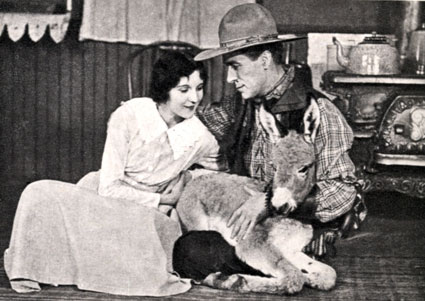 William S. Hart, Ann Little and a donkey make three. Taken during a break while filming either “Square Deal Sanderson” (‘19) or “Cradle of Courage” (‘20).