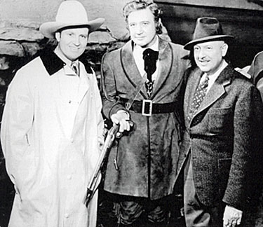 Gene Autry visits Richard Dix and director George Nicholls Jr. on the set of “Man of Conquest” (‘39 Republic).