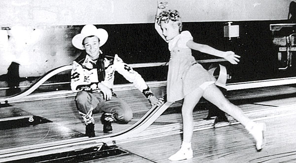 Republic’s juvenile star Twinkle Watts bowls a few frames with a little help from Roy Rogers. Circa 1945.