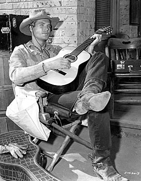 Ty Hardin relaxes with his guitar on the set of Warner Bros.’ “Bronco” in 1960.