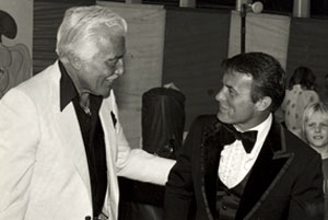 Cesar Romero greets Robert Conrad at a ‘60s affair.