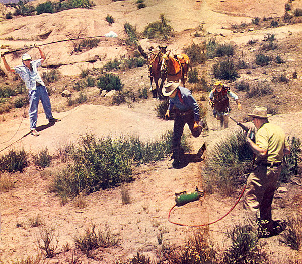 Filming an “Annie Oakley” action scene. Brad Johnson and Gail Davis run up a hill. The sound man in on the left, the prop man on the right will fire earth pellets to simulate dust kicked up by bullet shots.
