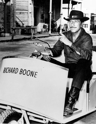 No horsin’ around for Paladin! Richard Boone gets around the “Have Gun Will Travel” backlot in a golf cart.
