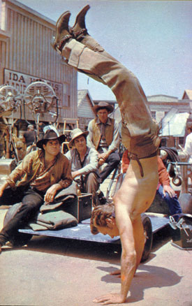 Clint Eastwood limbers up between takes on the set of “Rawhide”.