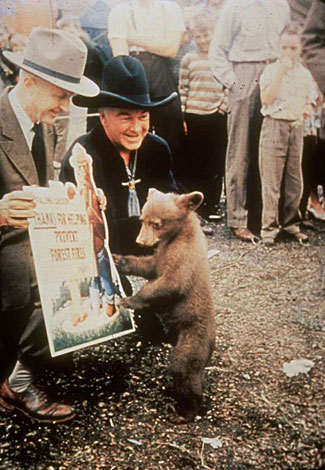 Hopalong Cassidy and Smokey the Bear thank the folks for helping to prevent forest fires.