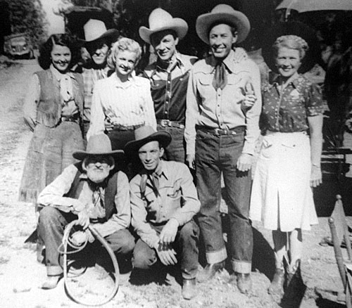Group photo taken in the mid ‘40s during one of Roy Rogers’ Republic Westerns. Top row L-R: riding double Mildred Jenkins, Tim Spencer, Dale Evans, Roy Rogers, Karl Farr, unknown. Kneeling: Gabby Hayes, Ken Carson. (Photo from the family of Mildred Jenkins.)