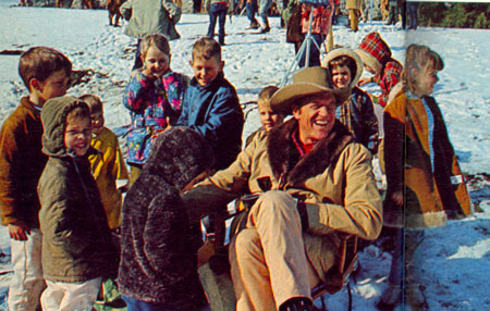 James Arness surrounded by a group of young admirers in Custer, SD for the filming of “Gunsmoke: Snow Train” in 1970. Executive producer John Mantley got lucky when a freak blizzard blanketed the area and permitted him to use a script he'd been ready to discard. Mantley immediately rushed his crew to the Black Hills.
