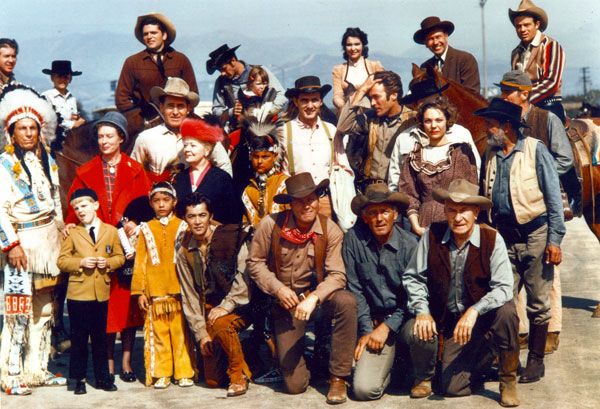 A terrific roundup of TV Western heroes...but for what event? Anyone have any idea? Top Row (L-R) Clu Gulager (“Tall Man”), Bruce Yarnell (“Outlaws”), Robert Fuller (“Laramie”), frequent TV Western guest star Suzanne Lloyd, Richard Eastham (“Tombstone Territory”), Jack Ging (“Tales of Wells Fargo”). Middle Row (L-R) Iron Eyes Cody, Ann Doran (“Legend of Jesse James”), Sheb Wooley (“Rawhide”), Spring Byington (“Laramie”), Dennis Weaver (“Gunsmoke”), Clint Eastwood (“Rawhide”), frequent guest star Joanna Moore, Frank McGrath (“Wagon Train”), James Murdock (“Rawhide”). Front Row (Kneeling L-R) Robert Cabal (“Rawhide”), John Smith (“Laramie”), Terry Wilson (“Wagon Train”), William Demarest (“Tales of Wells Fargo”). Photo looks to have been taken at a 1962 event.