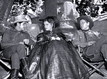 Bob Steele, Alexis Smith and Joel McCrea take a break from filming “South of St. Louis” (‘49 Warner Bros.).