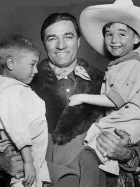 Tom Mix makes a couple of young fans very happy!