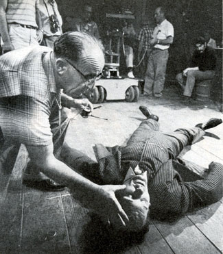 To simulate bruises a make-up man daubs makeup on the face of Robert Rockwell for an episode of TV’s “Man From Blackhawk” after Bob is knocked out in a brawl. 
