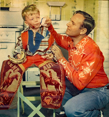 Gene Autry cleans up the face of little Jeffrey Burch after the youngster had a slight accident with his jelly sandwich. Gene and Ina were babysitting for Gene’s radio 
program producer Bill Burch and his wife in October 1950. 