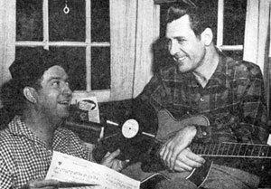 Singer/actor Doye O’Dell talks over his new record with Smiley Burnette in 1947.