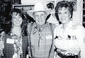 Stuntman and artist Walt LaRue happily finds himself surrounded by Susan Deland (left), the former Gene Autry Museum’s director of merchandise operations, and the late Joanne Hale, Monte’s widow, who was the Autry Museum’s executive director.