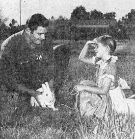 6'6";, 235 lb. Clint Walker helps daughter Valerie Jean with her pet rabbit.