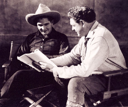 Bob Steele and his father, director Robert Bradbury, look over a script for one of Bob's early B-westerns.