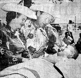 Newspaper photo of Roy Rogers and Dale Evans, starring at the New Mexico State Fair in October, 1957. Visiting local hospitals, here they talk with Rex Richards who recalled meeting Roy back in 1947.