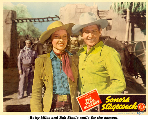 Betty Miles and Bob Steele smile for the camera on the scene card from "Sonora Stagecoach".
