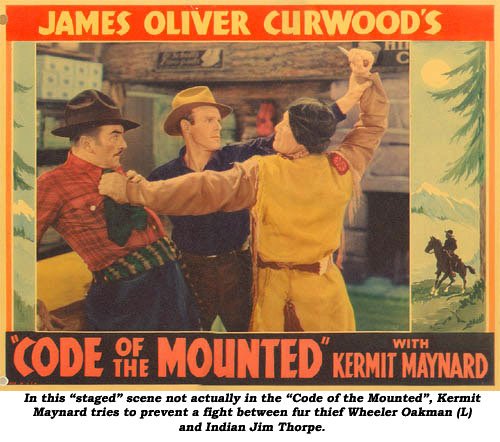 In this "staged" scene not actually in the "Code of the Mounted", Kermit Maynard tries to prevent a fight between fur thief Wheeler Oakman (L) and Indian Jim Thorpe.