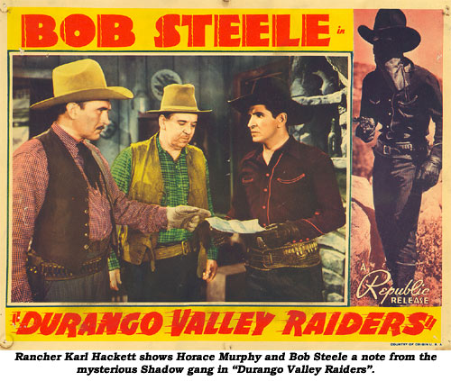 Rancher Karl Hackett shows Horace Murphy and Bob Steele a note from the mysterious Shadow gang in "Durango Valley Raiders".